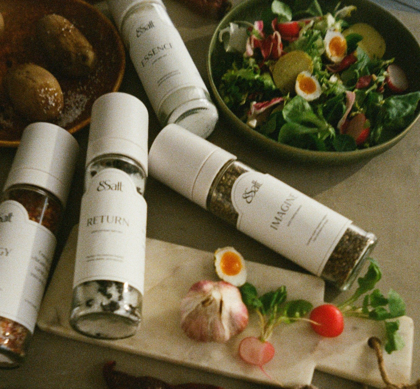 salt with spice blends in glass grinders