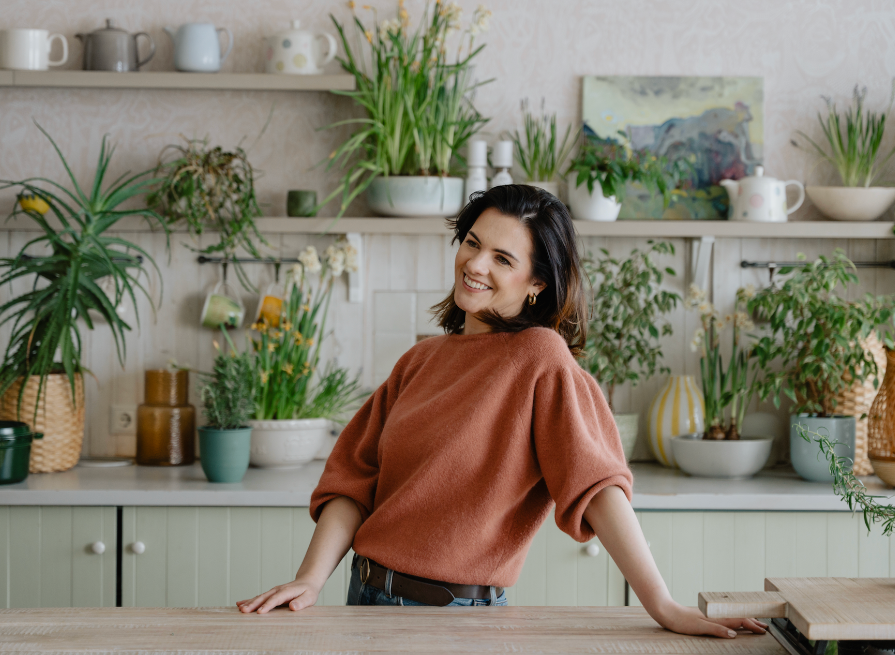 the founder of andsalt dainora remeza happy in the studio with plants in the background