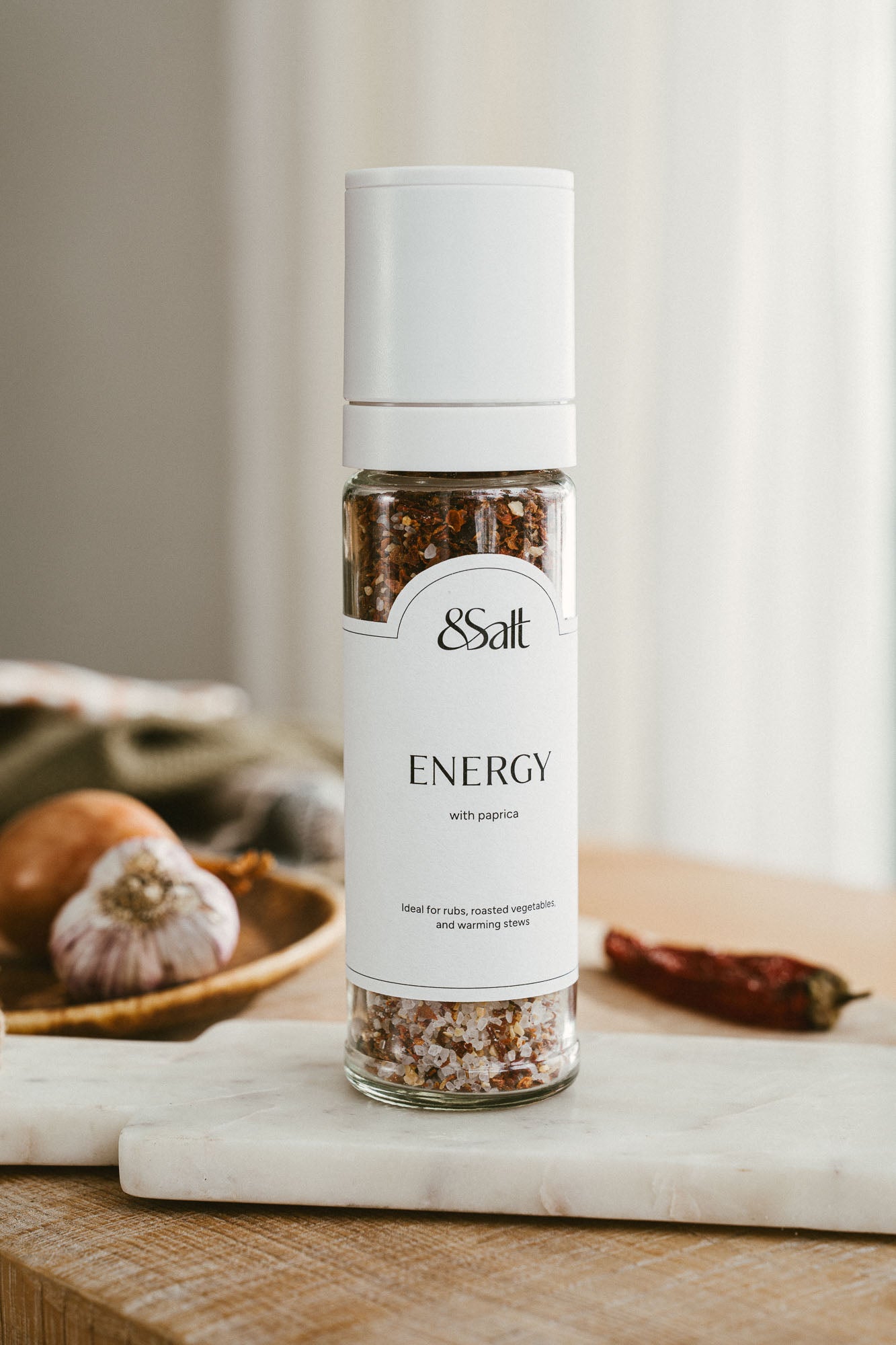 ENERGY sea salt and spice grinder with paprika in a tall refillable glass bottle