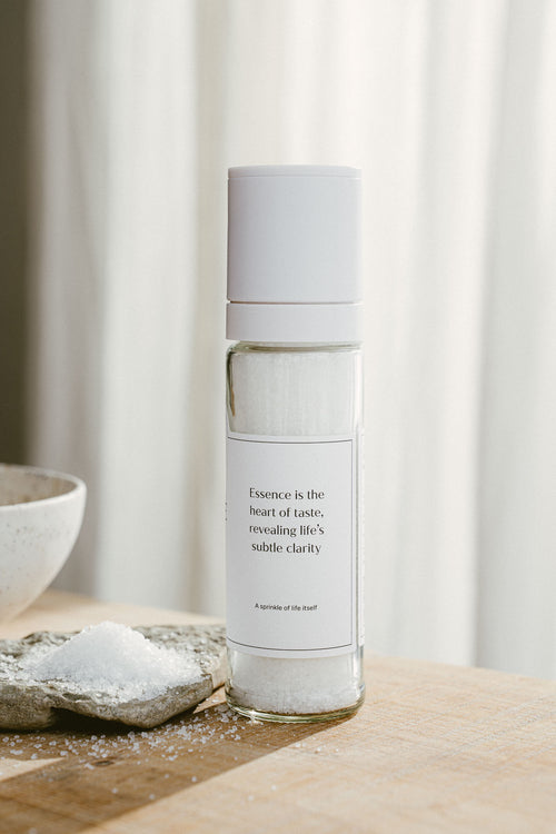 Bottle of essential oil with a white label on a wooden surface