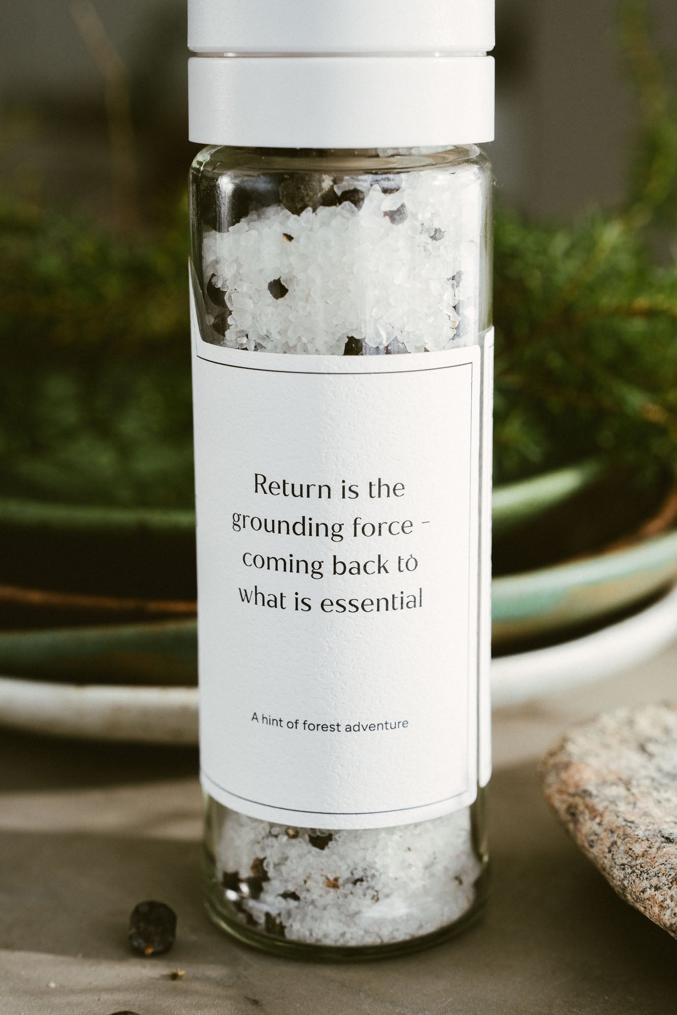 Bottle of salt with a label on a natural background